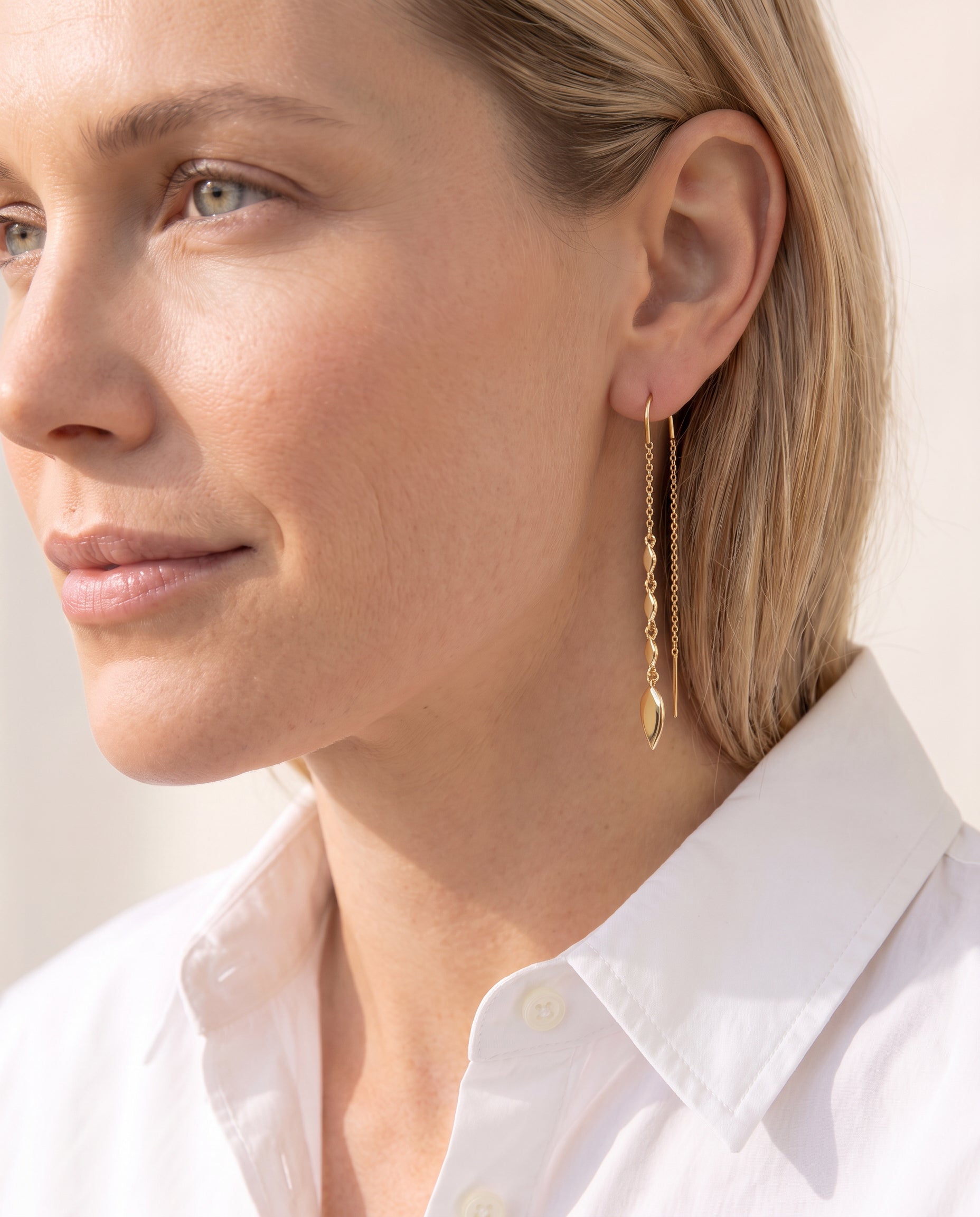 Woman wearing the Grace Ear Threaders in Gold by Natalie Wood Designs