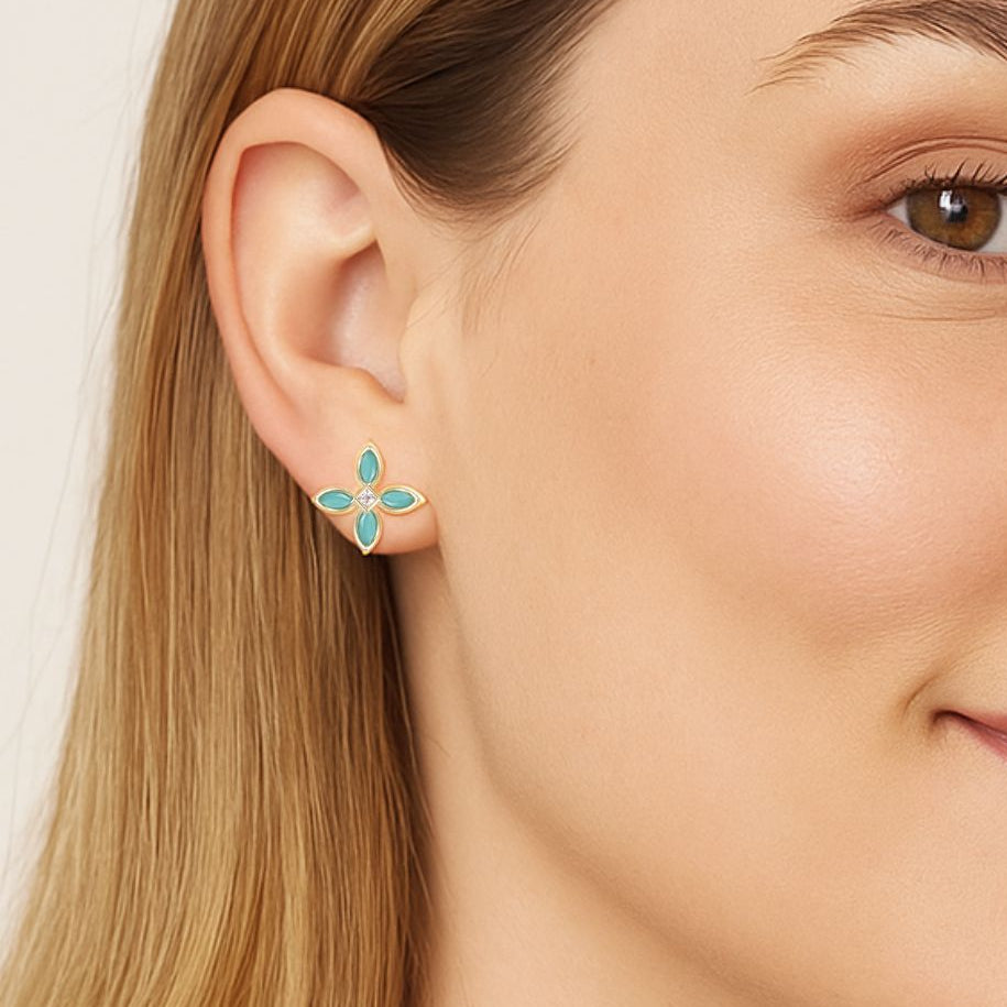 Close-up of a woman wearing a floral earring with a neutral background