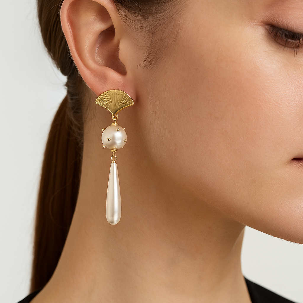 Pearl seashell earring with gold accents worn by a model on a white background