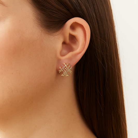 Photo of a girl's ear wearing the Natalie Wood Designs Logo Stud Earrings in gold