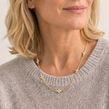 Woman wearing the Believer Cross Mini Necklace by Natalie Wood Designs