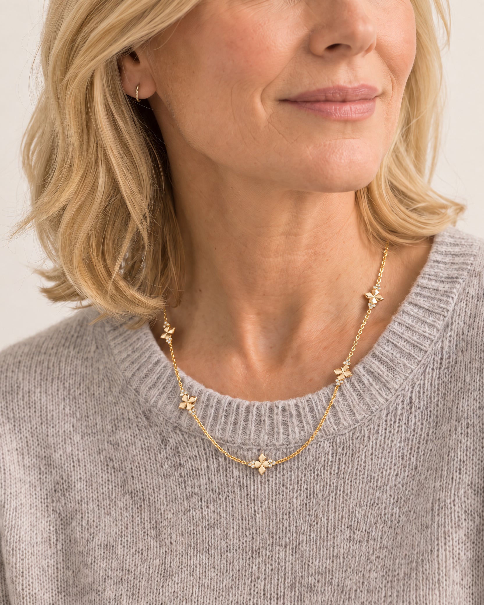 Woman wearing the Believer Cross Mini Necklace by Natalie Wood Designs