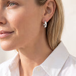 Woman wearing the Silver Just Dance Mini Tube Hoop Earrings by Natalie Wood Designs